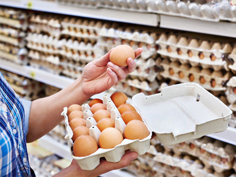 woman holding eggs at the store